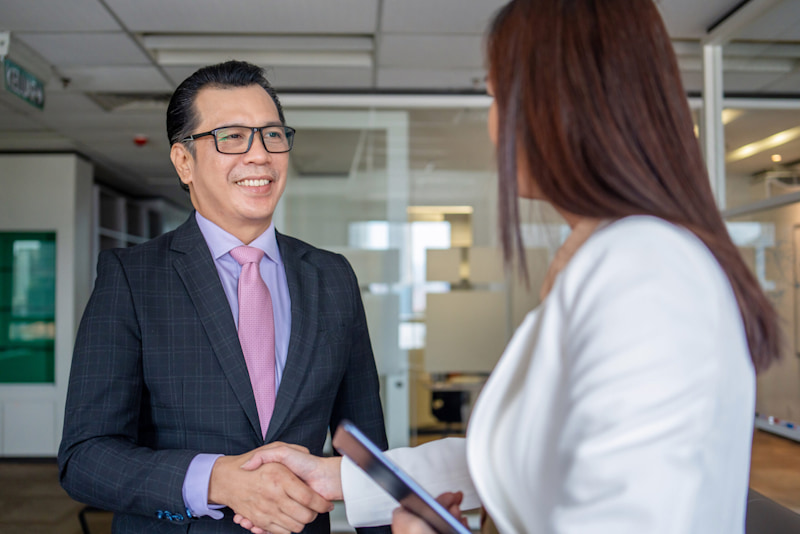 Man and woman shake hands